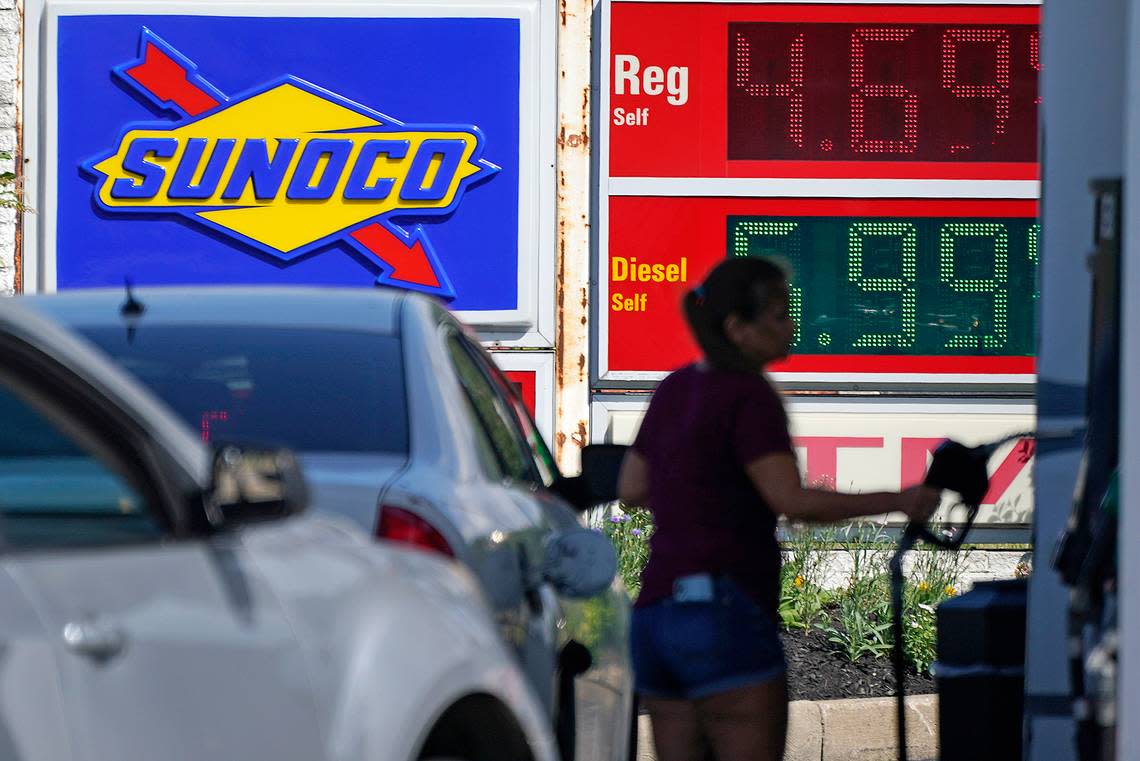 A woman pumps gas at a Sunoco mini-mart in Independence, Ohio, on Tuesday, July 12, 2022. (AP Photo/Gene J. Puskar)