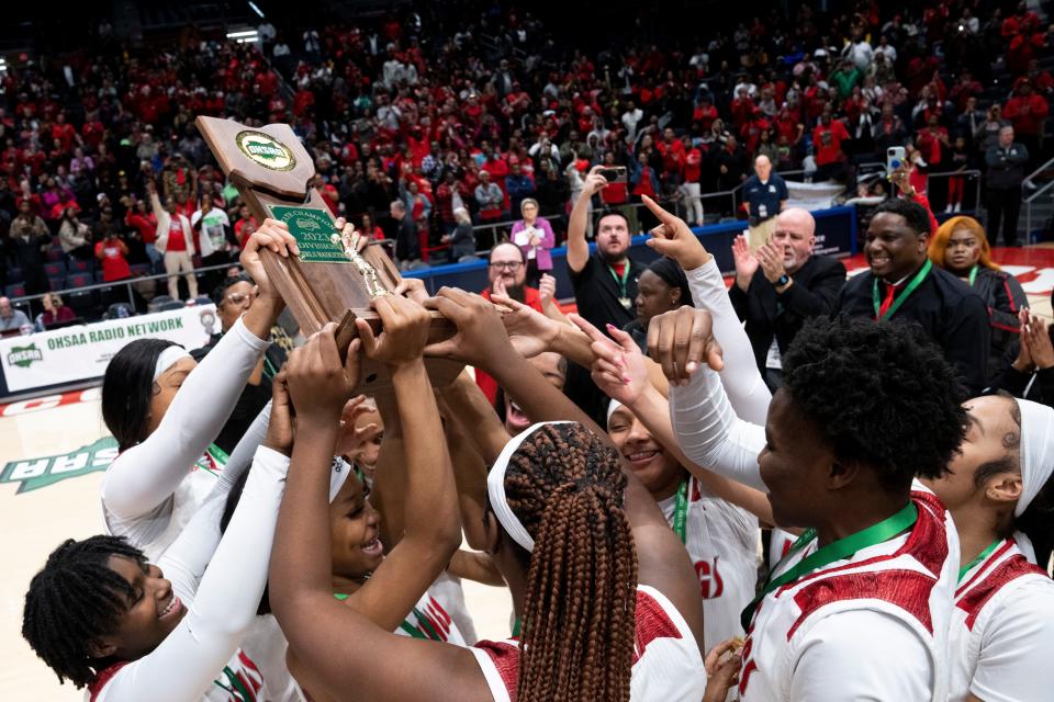 Princeton guard Sole Williams (15) holds up the state trophy with the rest of her team after winning the OHSAA Division I state championship game at the University of Dayton Arena in Dayton, Ohio, on Saturday, March 11, 2023. Princeton defeated Olmsted Falls 69-51. 