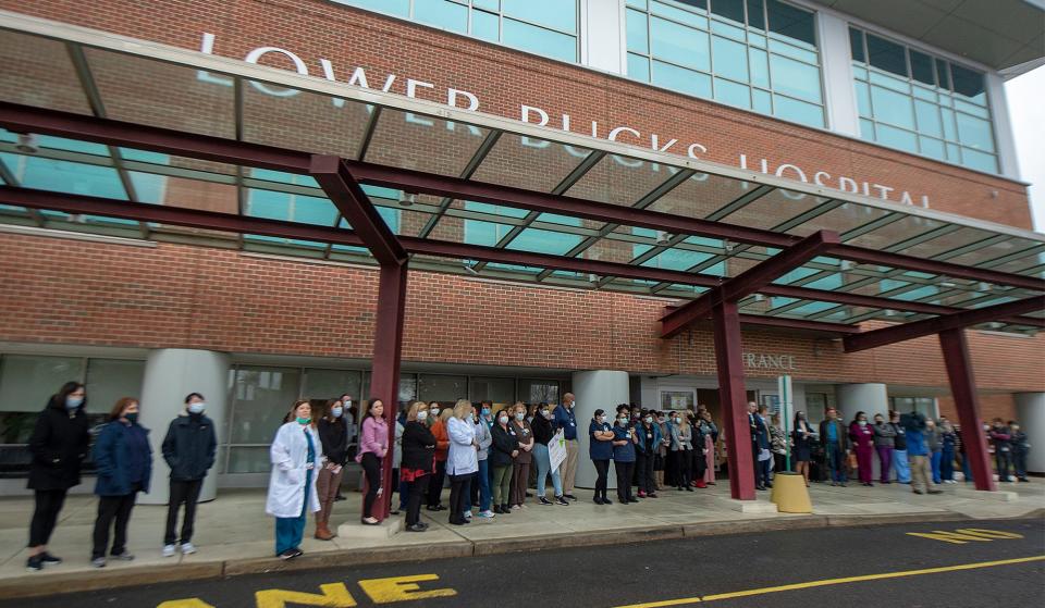 Nurses ands staff gather outside the front entrance to listen to the Harry S. Truman High School Band, during the second annual Healthcare Workers Appreciation, created by Gene and Marlene Epstein Humanitarian Foundation, held at Lower Bucks Hospital in Bristol Township, on Thursday, March 24, 2022.