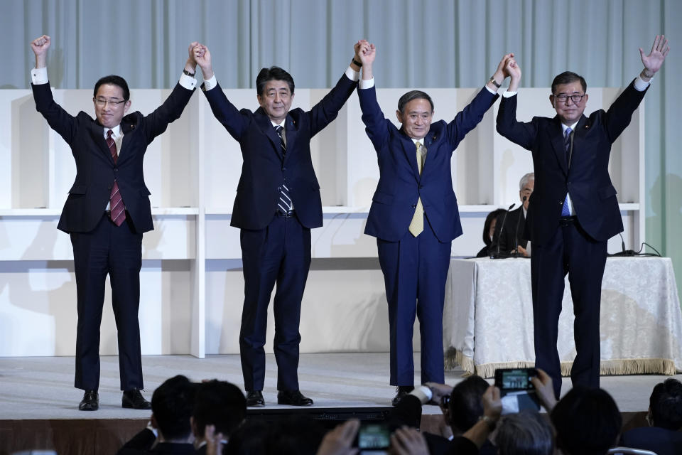 Former Foreign Minister Fumio Kishida, left, Japan's Prime Minister Shinzo Abe, Chief Cabinet Secretary Yoshihide Suga and former Defense Minister Shigeru Ishiba celebrate after Suga was elected as new head of Japan's ruling party at the Liberal Democratic Party's (LDP) leadership election Monday, Sept. 14, 2020, in Tokyo. The ruling LDP chooses its new leader in an internal vote to pick a successor to Prime Minister Shinzo Abe, who announced his intention to resign last month due to illness. (AP Photo/Eugene Hoshiko, Pool)