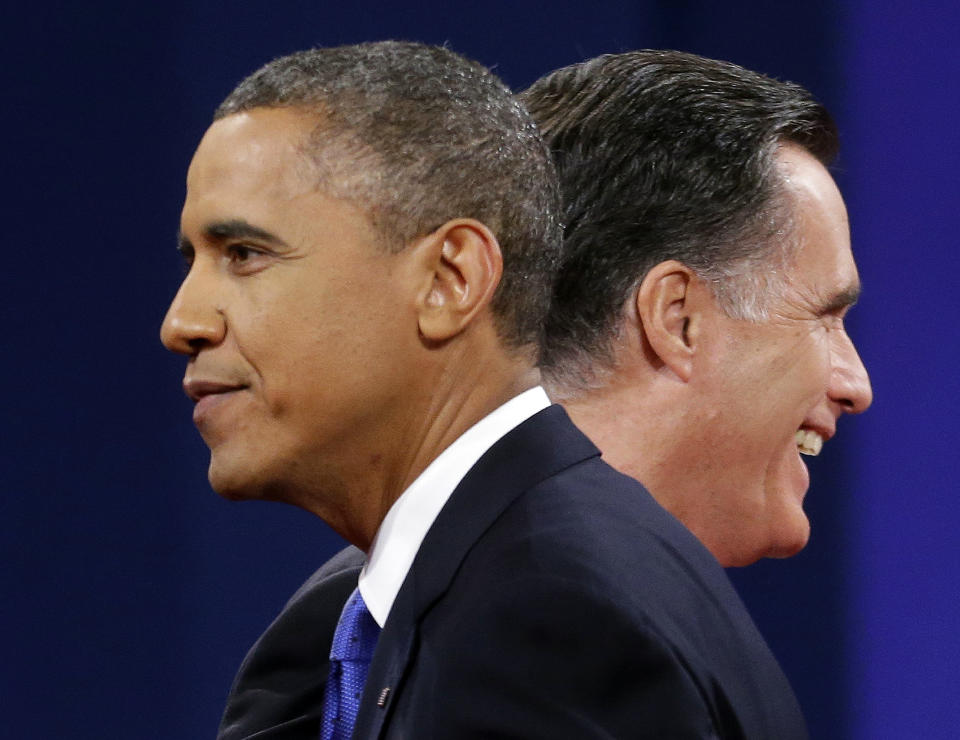 Republican presidential candidate, former Massachusetts Gov. Mitt Romney and President Barack Obama walks past each other on stage at the end of the last debate at Lynn University, Monday, Oct. 22, 2012, in Boca Raton, Fla. (AP Photo/Pablo Martinez Monsivais)