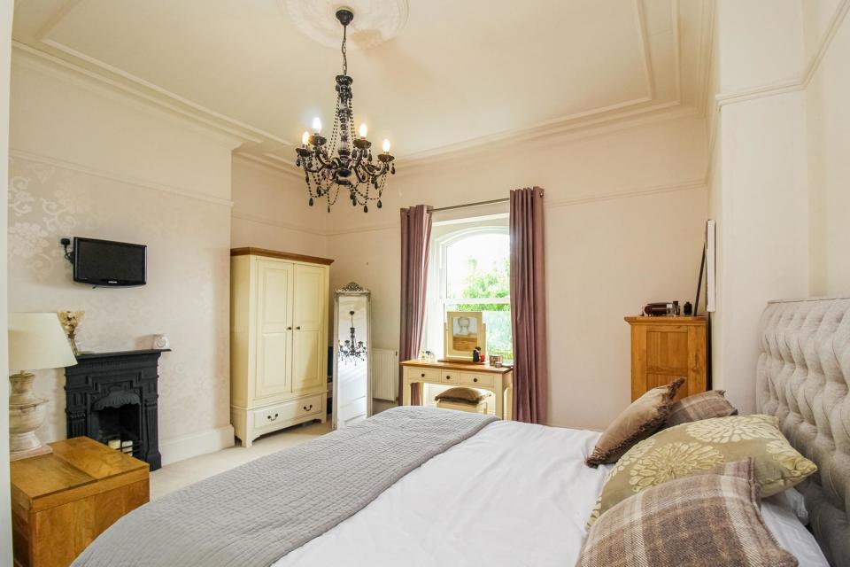 A spacious double bedroom with period decorative detail, and feature fireplace. (Photo: Richard Kendall Estate Agent, Wakefield)