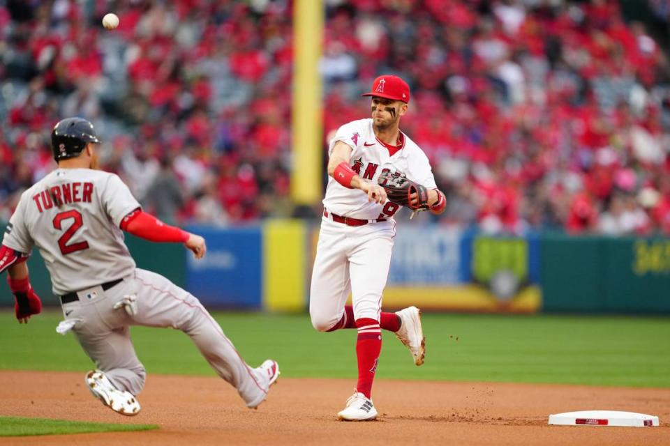 Los Angeles Angels shortstop Zach Neto (9) forces out Boston Red Sox first baseman Justin Turner (2) at second base in the first inning at Angel Stadium on Wednesday, May 24, 2023.