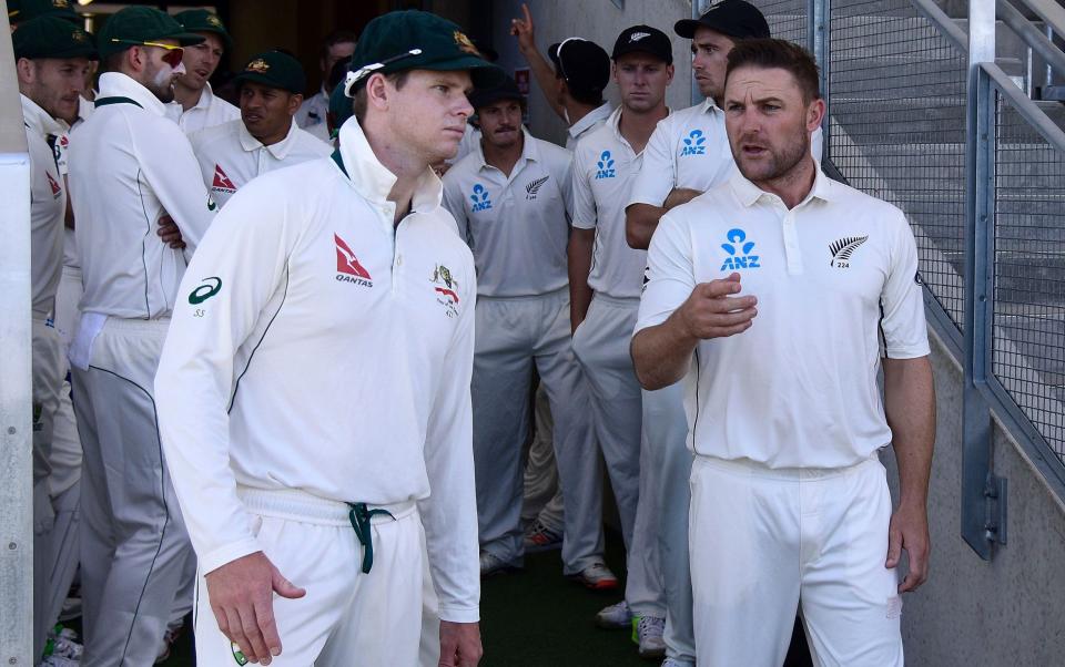 Steve Smith (L) captain of Australia with Brendon McCullum (R captain of New Zealand walk out into the field for the national anthems during day one of the second cricket Test match between New Zealand and Australia at the Hagley Park in Christchurch on February - AFP