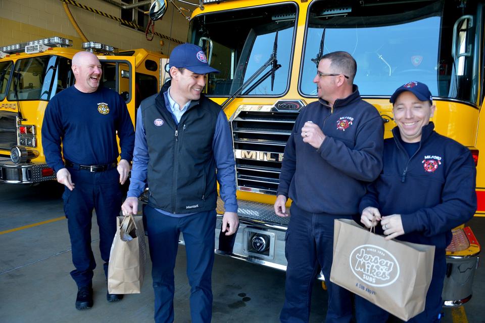 Brian O'Loughlin, second from left, co-owner of the new Milford Jersey Mike's franchise, brings lunch to the Milford Fire Department, April 4, 2022. From left are firefighters Mike Curley, D.J. Renaud and Chris Aut. From Wednesday through Sunday, the local Jersey Mike's is raising money for the Milford High School Athletic Department.