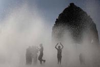MEXICO: Youths play in a fountain at Mexico City's Monument to the Revolution.