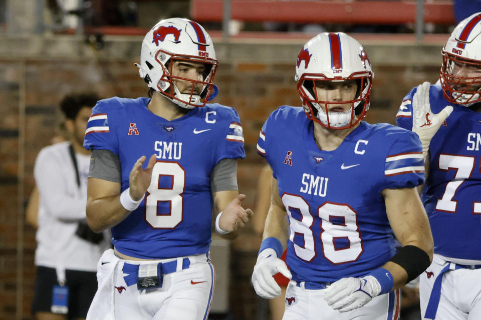 FILE - SMU quarterback Tanner Mordecai (8) and tight end Grant Calcaterra (88) jog onto the field during the first half of the team's NCAA college football game against Tulane in Dallas, Thursday, Oct. 21, 2021. Mordecai has already set a single-season SMU record with 37 touchdown passes after finally getting his opportunity to be a starting quarterback, which is no surprise to his former teammate at Oklahoma that he recruited to join him on the Hilltop. (AP Photo/Michael Ainsworth, File)