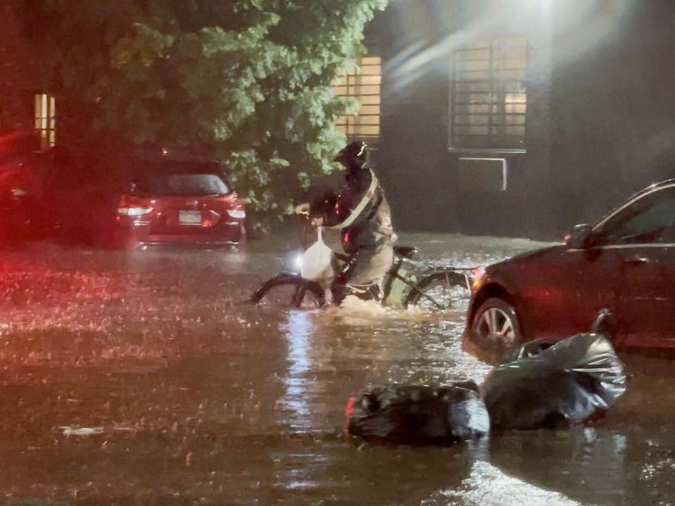 delivery driver on bicycle navigates ida floodwaters in nyc