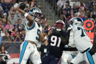 Carolina Panthers quarterback Matt Corral (9) passes under pressure from New England Patriots defensive end Deatrich Wise Jr. (91) during the first half of a preseason NFL football game Friday, Aug. 19, 2022, in Foxborough, Mass. (AP Photo/Michael Dwyer)