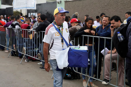 A Venezuelan citizen sells arepas outside the Interpol office in Lima, Peru, May 10, 2018. Picture taken May 10, 2018. REUTERS/Guadalupe Pardo