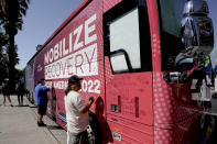 Sa Thao signs the 2022 Mobile Recovery National Bus during a stop at the Capitol in Sacramento, Calif. Sept. 7, 2022. Across the country, people in recovery and relatives of those killed by opioid overdoses are pressing for roles in determining how billions in opioid settlement money will be used. That push is one of the missions of the monthlong nationwide bus tour. Thao was addicted to methamphetamine but through recovery programs has been clean for 18 months. (AP Photo/Rich Pedroncelli)