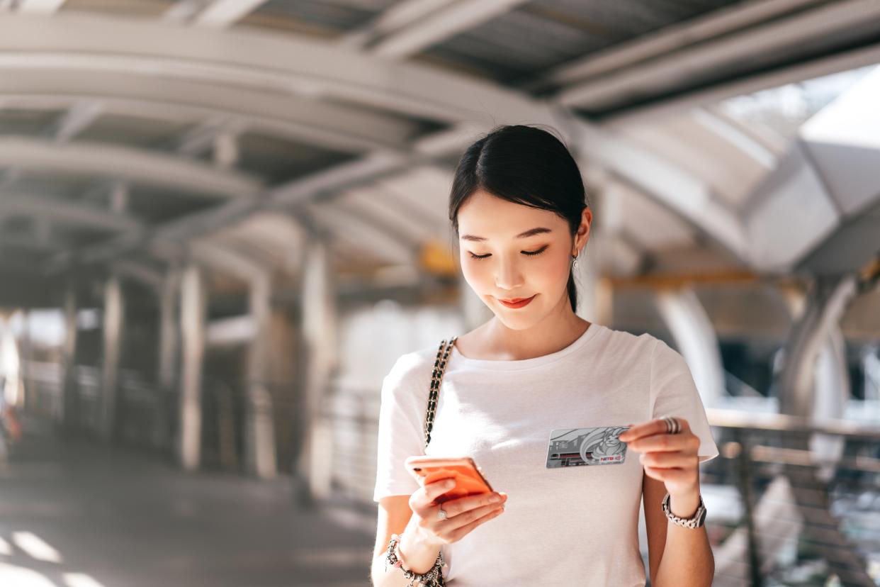 Young woman making online payment with a card.