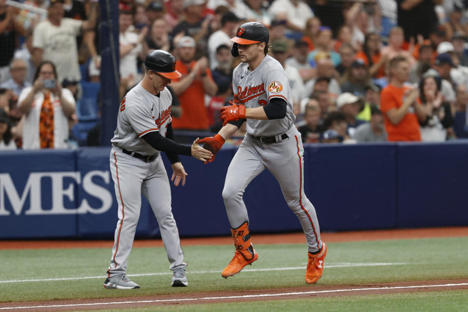 Baltimore Orioles' Gunnar Henderson, right, celebrates with third base coach Tony Mansolino, left, after hitting a two-run home run against the Tampa Bay Rays during the second inning of a baseball game Sunday, July 23, 2023, in St. Petersburg, Fla. (AP Photo/Scott Audette)