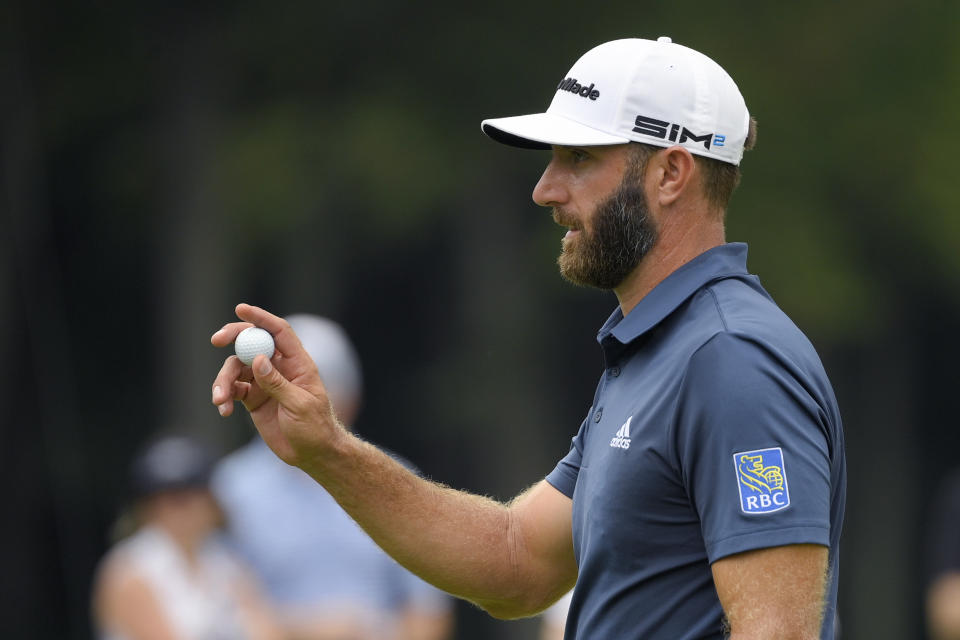 Dustin Johnson gestures after putting on the fourth green during the final round of the BMW Championship golf tournament, Sunday, Aug. 29, 2021, at Caves Valley Golf Club in Owings Mills, Md. (AP Photo/Nick Wass)