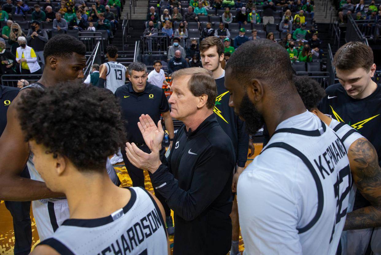 Oregon coach Dana Altman, center, brings his team together before their game against Arizona State.