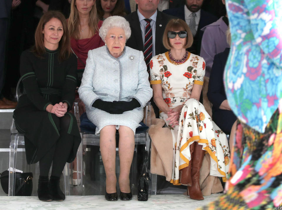 Britain's Queen Elizabeth II, accompanied by Chief Executive of the British Fashion Council (BFC), Caroline Rush (L) and British-American journalist and editor, Anna Wintour (R), views British designer Richard Quinn's runway show before presenting him with the inaugural Queen Elizabeth II Award for British Design, during her visit to London Fashion Week's BFC Show Space in central London on February 20, 2018. (Photo by Yui Mok / POOL / AFP) (Photo by YUI MOK/POOL/AFP via Getty Images)