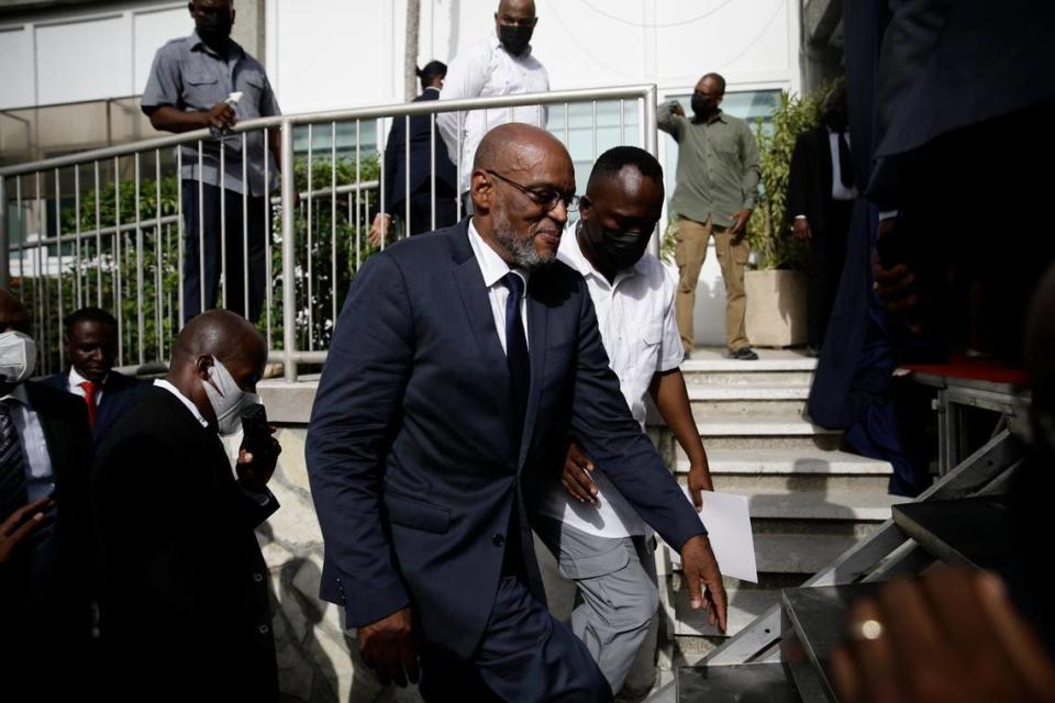 New Haitian Prime Minister Ariel Henry walks up a set of stairs escorted by his security detail in Port-au-Prince after taking office on July 20, 2021, weeks after the assassination of President Jovenel Moïse.