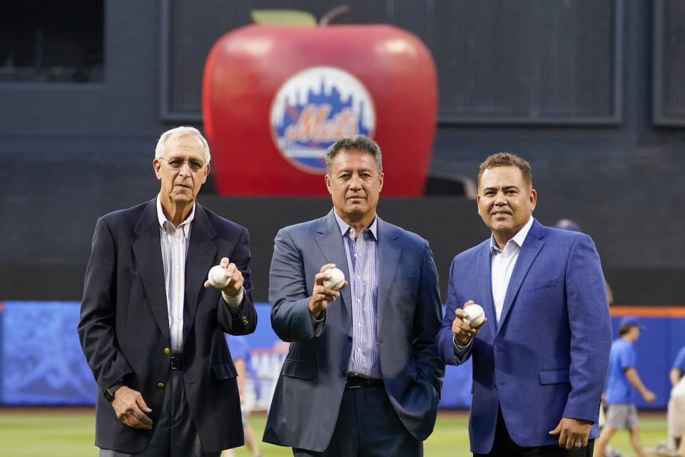 New York Mets Hall of Fame inductees Ron Darling, right, pitcher Jon Matlack, center, and infielder Edgardo Alfonzo pose for a photo during the induction ceremony, Saturday, July 31, 2021, in New York. (AP Photo/Mary Altaffer)