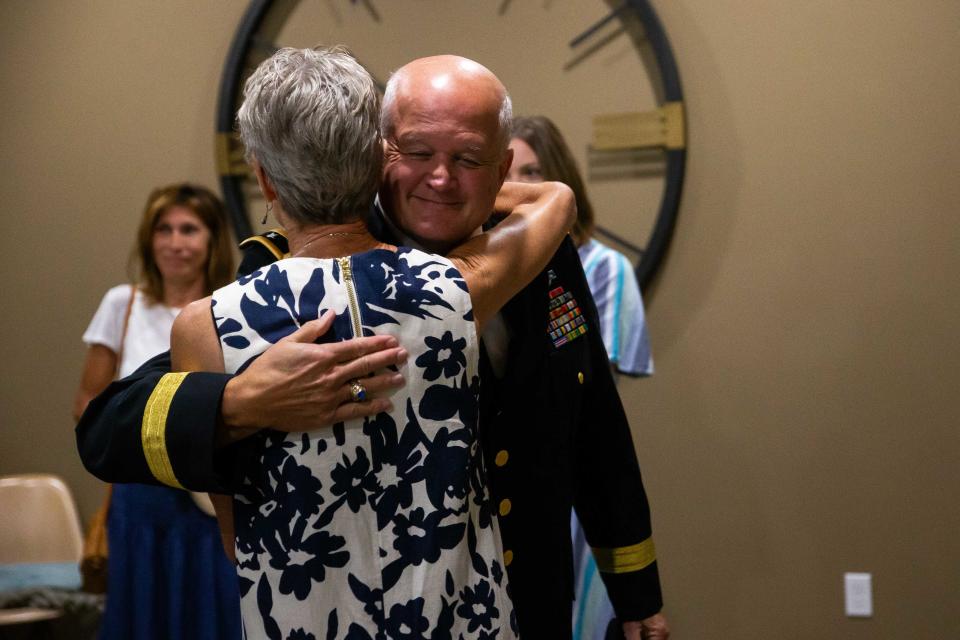 Army Brigadier General Richard Miller hugs Tamsin Troff as he arrives to present Mary Tyndall Troff's father's WWI medals Tuesday, Aug. 16, 2022, at Seventy-Six Restaurant in Holland. 