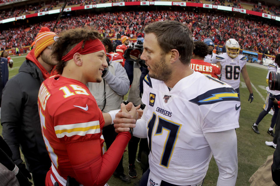 Kansas City Chiefs quarterback Patrick Mahomes (15) and Los Angeles Chargers quarterback Philip Rivers (17) talk after an NFL football game Sunday, Dec. 29, 2019, in Kansas City, Mo. (AP Photo/Charlie Riedel)