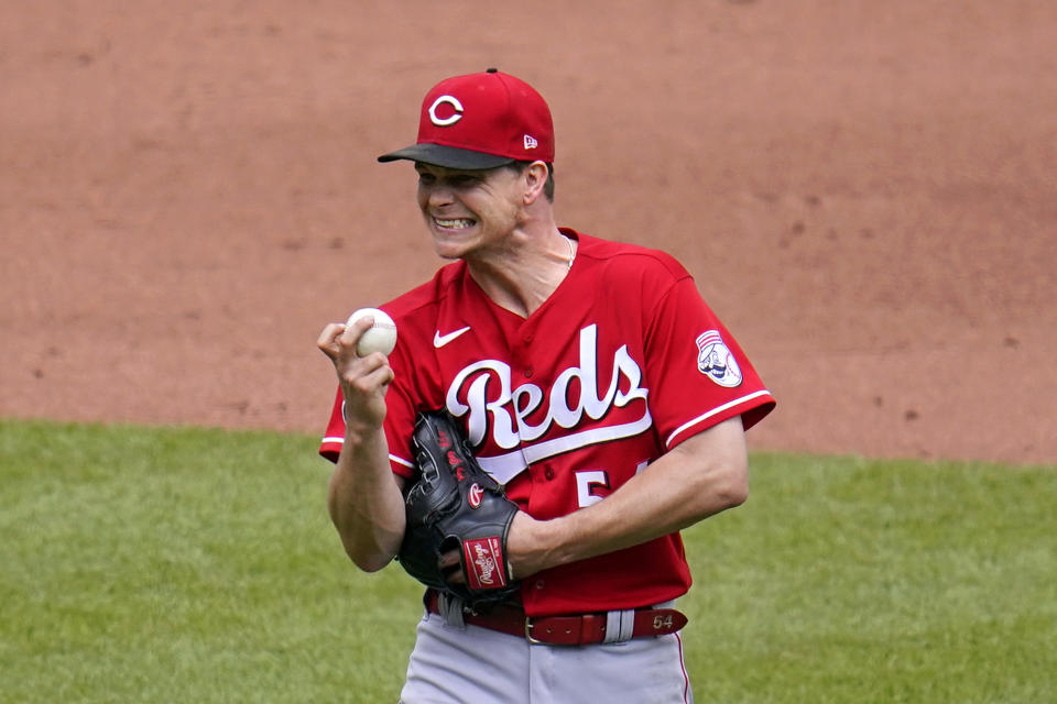 Cincinnati Reds starting pitcher Sonny Gray waits to hand the ball to manager David Bell during the fifth inning of a baseball game against the Pittsburgh Pirates in Pittsburgh, Wednesday, May 12, 2021.(AP Photo/Gene J. Puskar)