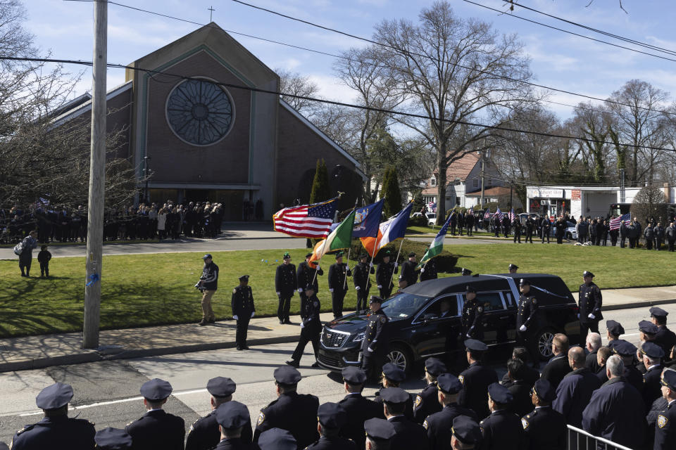 The casket containing New York Ciity Police department officer Jonathan Diller's body arrives at Saint Rose of Lima R.C Church in Massapequa Park, N.Y., on Saturday, March 30, 2024. Diller was shot dead Monday during a traffic stop. He was the first New York City police officer killed in the line of duty in two years.(AP Photo/Jeenah Moon)