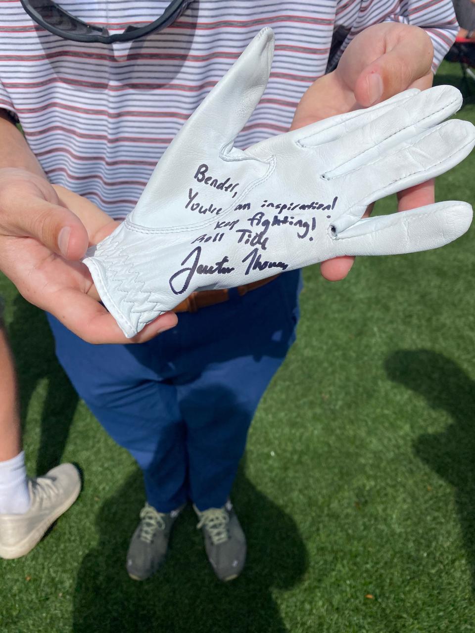 Bender Middlekauf of Jacksonville shows off the autographed glove he got from PGA Tour player and fellow Alabama fan Justin Thomas.