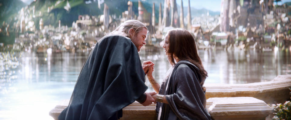 as they stand before a glittering lake on Asgard, Thor and Jane hold hands and gaze lovingly into each other&#39;s eyes