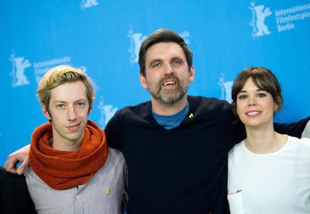 Director Sebastian Schipper (C) and cast members, Max Mauff (L) and Laia Costa, pose during a photocall to promote the in competition film "Victoria" at the 65th Berlinale International Film Festival in Berlin February 7, 2015. REUTERS/Stefanie Loos