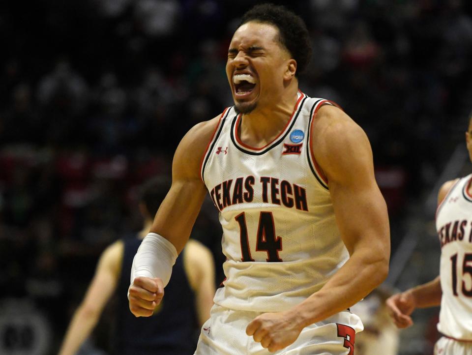 Texas Tech's Marcus Santos-Silva (14) reacts to a play against Notre Dame in the NCAA tournament's second round game, Sunday, March 20, 2022, at Viejas Arena in San Diego, California. Texas Tech won, 59-53.