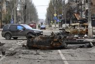 A part of a destroyed tank and a burned vehicle sit in an area controlled by Russian-backed separatist forces in Mariupol, Ukraine, Saturday, April 23, 2022. (AP Photo/Alexei Alexandrov)