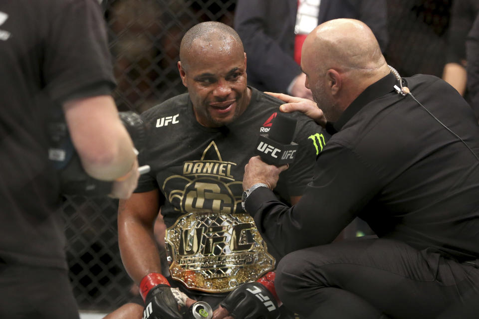 Daniel Cormier is interviewed by Joe Rogan after a win over Volkan Oezdemir after a light-heavyweight championship mixed martial arts bout at UFC 220, Saturday, January 20, 2018, in Boston. Cormier retained the title via 2nd round TKO. (AP)