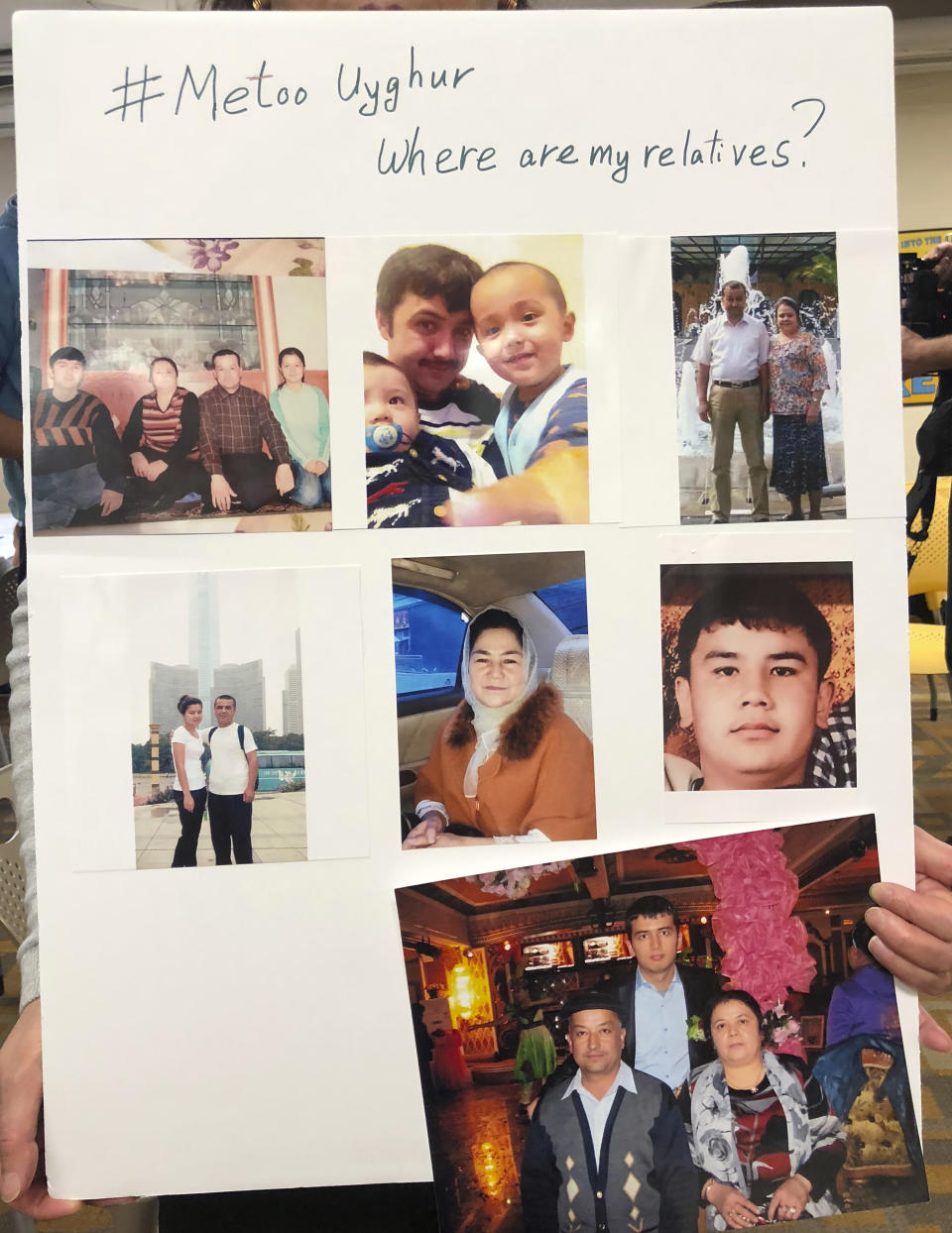 FILE - In this file photo taken Sunday, Feb. 24, 2019, a poster showing missing relatives is displayed during a gathering to raise awareness about loved ones who have disappeared in China's far west Xinjiang region in Washington DC. The accusation of genocide by U.S. Secretary of State Mike Pompeo against China touches on a hot-button human rights issue between China and the West. (AP Photo/Christina Larson, File)