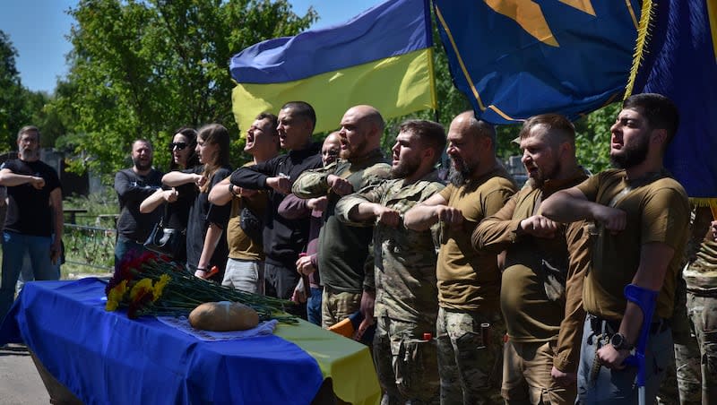 Ukrainian servicemen pay their last respects to their fellow soldier Andriy Chyshko of the 3rd Assault Brigade who was killed in a battle with Russian troops in the Donetsk region, during his funeral ceremony in Zaporizhzhia, Ukraine, Thursday, May 2, 2024.