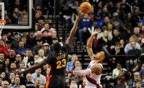 Feb 19, 2016; Portland, OR, USA; Portland Trail Blazers guard Damian Lillard (0) hits a shot over Golden State Warriors forward Draymond Green (23) during the third quarter of the game at the Moda Center at the Rose Quarter. The Blazers won the game 137-105. Mandatory Credit: Steve Dykes-USA TODAY Sports