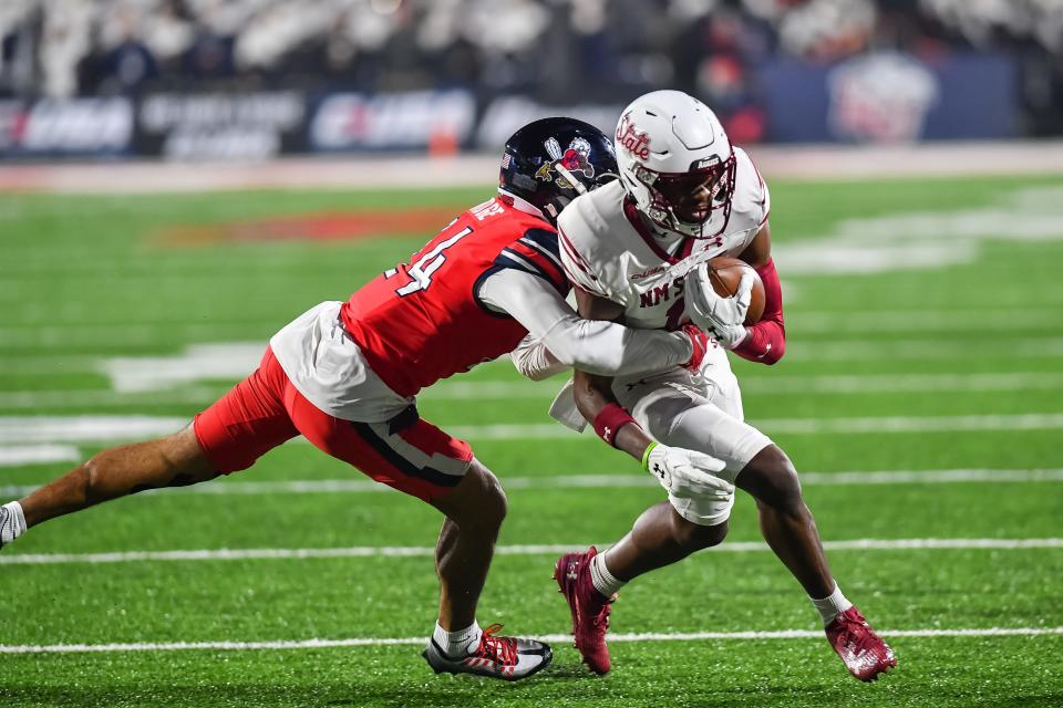 Liberty Flames defensive back Preston Hodge (24) tackles New Mexico State Aggies wide receiver Kordell David (11) after a catch during the third quarter at Williams Stadium on Dec. 1, 2023, in Lynchburg, VA.