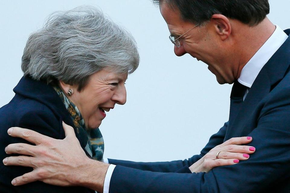 Brexit embrace: Mrs May and Mark Rutte (AP)