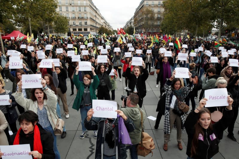 People attend a demonstration against femicide and violence against women at Place de la Republique in Paris