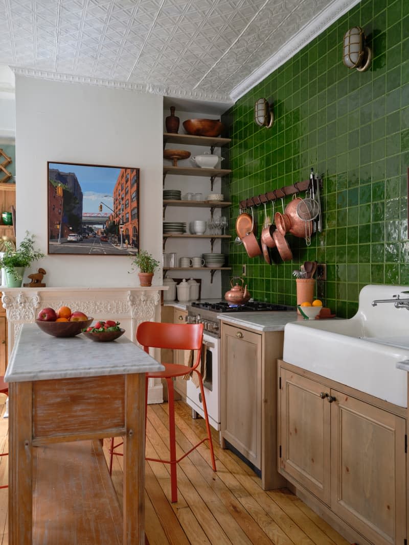 Green tiles and vintage elements in newly renovated kitchen.