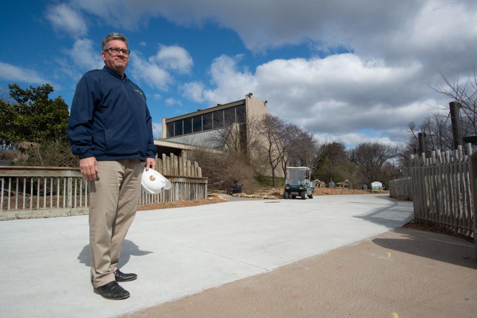 Brendan Wiley, CEO of the Topeka Zoo and Conservation Center, stands on a newly expanded concrete pathway on April 7, 2022, needed for an increase in visitors.