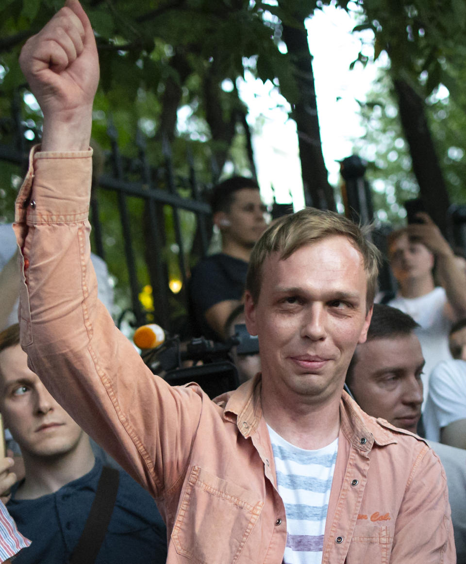 Prominent Russian investigative journalist Ivan Golunov, greets colleagues and his supporters as he leaves a Investigative Committee building in Moscow, Russia, Tuesday, June 11, 2019. In a surprising turnaround, Russia's police chief on Tuesday dropped all charges against a prominent investigative reporter whose detention sparked public outrage and promised to go after the police officers who tried to frame the journalist as a drug-dealer. (AP Photo/Alexander Zemlianichenko)