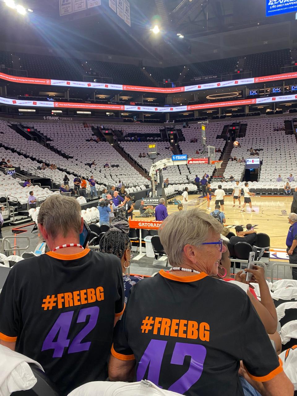 A.J. McRae and JoAnn McRae wear "#FreeBG 42" shirts at a WNBA basketball game between the Mercury and the Las Vegas Aces, Friday, May 6, 2022, in Phoenix.