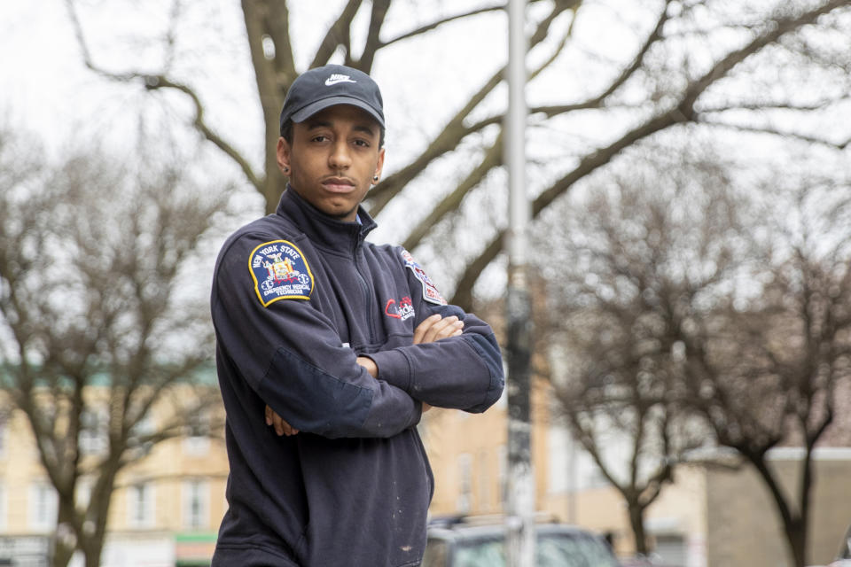 In this Saturday, April 4, 2020 photo, emergency medical technician Josh Allert poses for a photo in New York. Thousands of workers have been thrust onto the front lines of the coronavirus emergency in New York City. That includes Allert, whose days are a blur and a battle. (AP Photo/Mary Altaffer)
