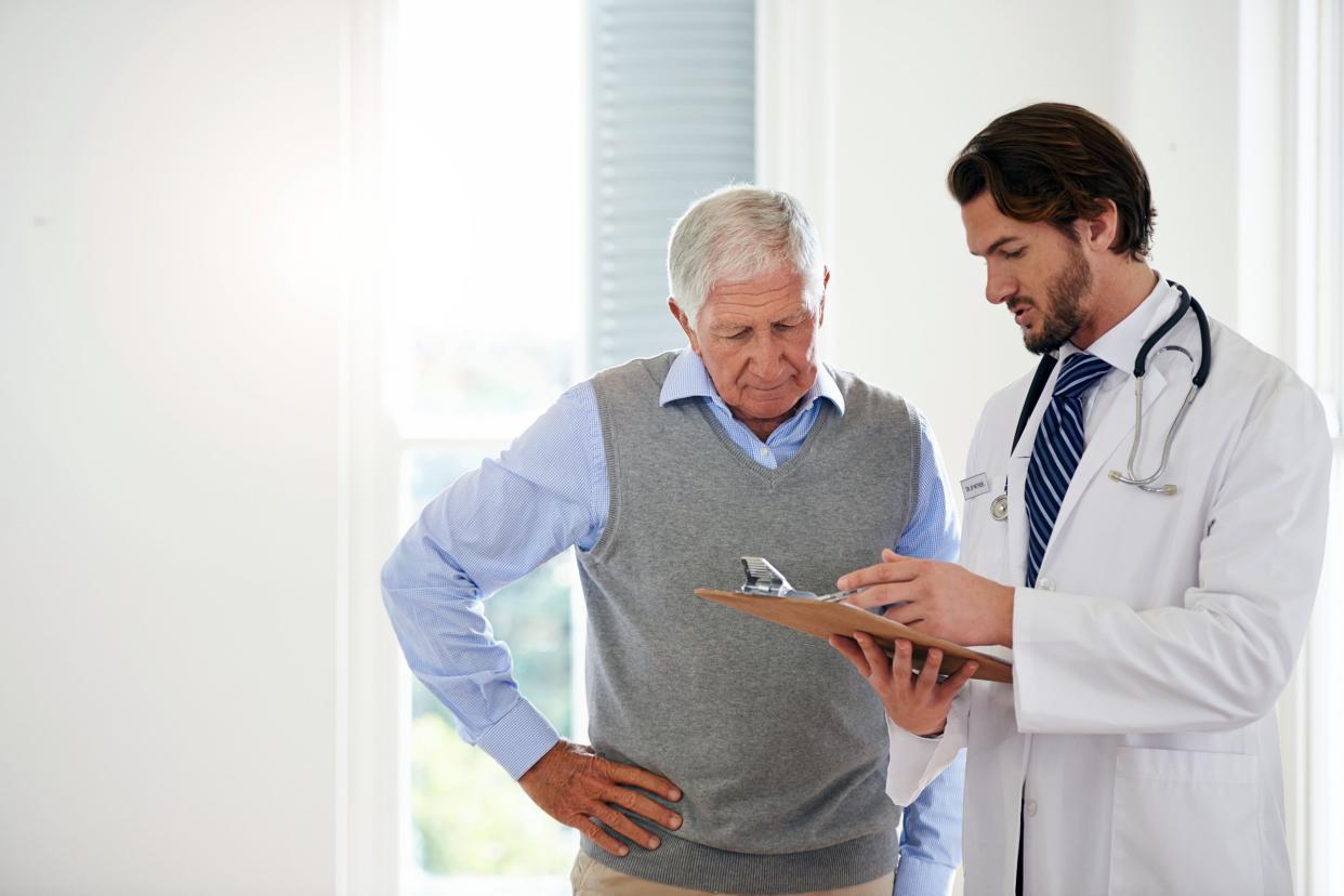 Concerned senior man speaking with a doctor