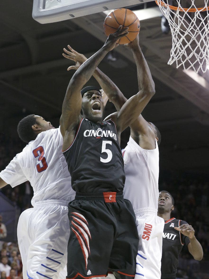 Cincinnati forward Justin Jackson (5) shoots between SMU guards Sterling Brown (3) and Keith Frazier during the first half of an NCAA college basketball game Saturday, Feb. 8, 2014, in Dallas. (AP Photo/LM Otero)