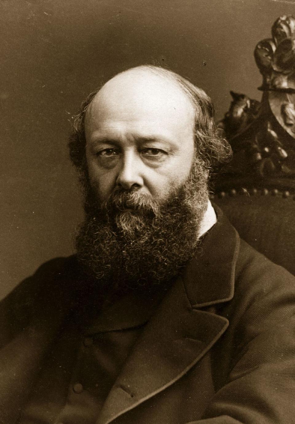 lord salisbury wears a jacket and formal attire as he stares at the camera