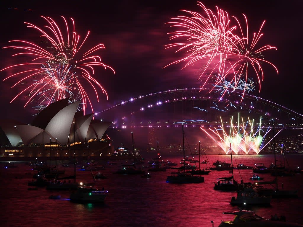 Fireworks explode over the Sydney Opera House and Harbour Bridge as New Year's Eve celebrations begin in Sydney (AP)