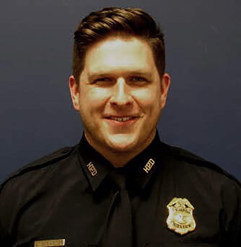 In this undated photo posted on Twitter and provided by the Houston Police Department is Sgt. Christopher Brewster, who was shot and killed Saturday evening, Dec. 7, 2019, by a man who had been reported for assault, authorities said. Police officials said in a tweet that the 32-year-old officer was shot just before 6 p.m. (Houston Police Department via AP)