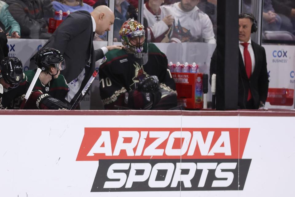 Arizona Coyotes head coach André Tourigny talks with goaltender Karel Vejmelka after being removed during the first period of the NHL game against the Calgary Flames at Mullett Arena on Jan. 11, 2024 in Tempe, Ariz.