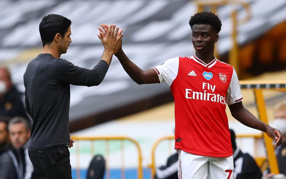 Mikel Arteta with young winger Bukayo Saka - AFP